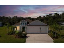 Charming single-story home boasting a spacious three-car garage and lush landscaping at 4515 Roycroft Ter, Parrish, FL 34219
