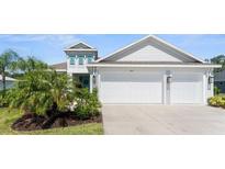 Charming single-story home with a two-car garage, well-manicured lawn, and lush landscaping at 4515 Roycroft Ter, Parrish, FL 34219