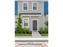 Charming townhome featuring a modern gray front door and nicely landscaped walkway at 8545 Daybreak St, Sarasota, FL 34241