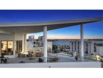 Stunning rooftop patio with ample seating and incredible bay views at twilight at 111 S Pineapple Ave # 1210, Sarasota, FL 34236