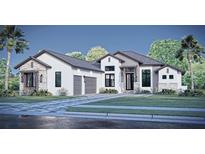 Stunning single-story home showcasing a modern design, stone accents, a gray tile roof and a well-manicured front yard at 11149 Price Ln, Myakka City, FL 34251