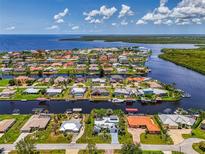 Stunning aerial view of waterfront homes, showcasing canals, docks, and lush landscaping in a coastal community at 127 Colonial Sw St, Port Charlotte, FL 33952