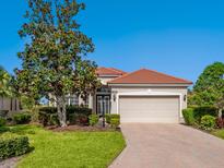 Charming single-story home boasts a well-manicured lawn, brick driveway and a tile roof at 1313 Thornapple Dr, Osprey, FL 34229