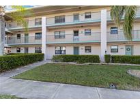 Three-story condo building has manicured landscaping, walkways, and private balconies at 175 Kings Hwy # B5, Punta Gorda, FL 33983