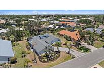 Beautiful aerial view of a modern home with a circular driveway, well-manicured landscaping, and a gray roof at 238 Lookout Point Dr, Osprey, FL 34229