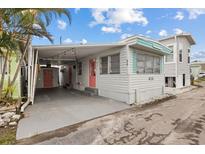 Charming home featuring covered parking, a bright pink door, and delightful nautical themed accents at 2601 Gulf N Dr # 317, Bradenton Beach, FL 34217