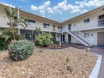 Well maintained condo complex shows courtyard with updated stairs and landscaping at 340 Base E Ave # 314, Venice, FL 34285