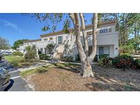 Charming townhome with stucco facade, lush landscaping, and a private entrance at 5269 Wedgewood Ln # 36, Sarasota, FL 34235