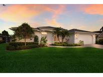 Charming single-story home boasting a well-manicured lawn, mature trees, and a two-car garage at 5782 Sandy Pointe Dr, Sarasota, FL 34233