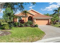 Charming home featuring a beautifully landscaped front yard and a brick driveway at 7231 Brambury Ct, Sarasota, FL 34238