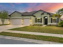 Charming single-story home with a well-manicured lawn and a three-car garage at 7418 61St E St, Palmetto, FL 34221