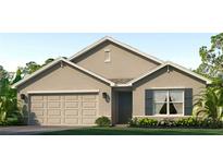 Charming single-story home showcasing a neutral stucco exterior, two-car garage, and well-maintained landscaping at 10844 Gentle Current Way, Parrish, FL 34219