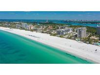 Beautiful aerial view of pristine white sand beach and turquoise water at Lido Beach Club in Sarasota, Florida at 1212 Benjamin Franklin Dr # 503, Sarasota, FL 34236