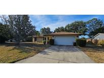 Single Gathering home features a large two-car garage and a well-kept lawn at 1218 Carmella Ln, Sarasota, FL 34243