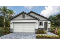 Charming single-story home with a two-car garage, stone accents, and landscaped front yard at 1848 Cobb Trl, Parrish, FL 34219