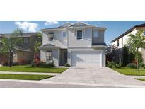 Charming two-story home with a welcoming facade, two-car garage, and a well-manicured lawn at 3111 W Nassau St, Tampa, FL 33607