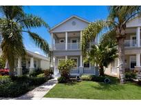 Charming two-story home featuring dual balconies and lush tropical landscaping at 5526 River Sound Ter, Bradenton, FL 34208