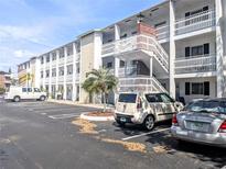 Condo building featuring well-maintained exteriors, parking, and community landscaping on a bright sunny day at 5951 Todd St # D37, Bradenton, FL 34207