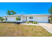 Charming single-story home features fresh white paint, a well-manicured lawn and simple landscaping at 6698 Acmar Ct, North Port, FL 34287
