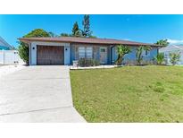 Charming single-story home featuring a well-manicured lawn and an attached garage at 8420 43Rd Avenue W Dr, Bradenton, FL 34209