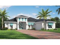 Beautiful single-story home featuring lush landscaping, a brick driveway, and charming turquoise accents on the windows and front door at 0 Jenny Dr, Nokomis, FL 34275