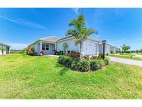 Beautiful single-story home boasts a well-manicured lawn, tropical landscaping, and a charming two-car garage at 1007 Waterline Ct, Sarasota, FL 34240