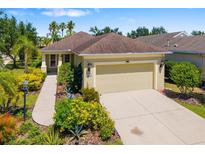 Charming single-story home featuring a two-car garage, well-manicured landscaping, and a concrete driveway at 11634 Piedmont Park Xing, Bradenton, FL 34211