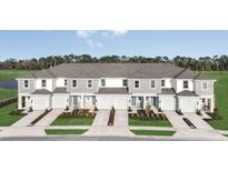 New townhomes with manicured lawns, private garages, and modern gray and white facades create curb appeal at 15117 Cuzcorro Ct, Nokomis, FL 34275