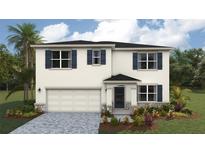 Two-story home features a two-car garage, blue shutters, a covered porch, and professionally landscaped yard at 1750 Cobb Trl, Parrish, FL 34219