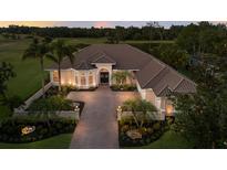 Stunning single Gathering home with a well manicured lawn and long brick driveway at 2301 Little Country Rd, Parrish, FL 34219