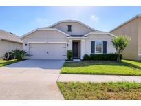 Charming single-story home features a well-manicured lawn and attached two-car garage at 309 Blue Point Dr, Ruskin, FL 33570