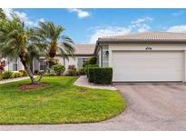 Charming single-story home featuring a two-car garage, lush landscaping, and a well-manicured lawn at 3130 Ringwood Mdw # 44, Sarasota, FL 34235