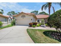 Charming home showcasing a lush, well-manicured lawn and red-tiled roof at 3412 E Chelmsford Ct # 42, Sarasota, FL 34235
