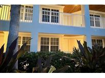 Inviting exterior view featuring a balcony and lush greenery surrounding the building at 3506 54Th W Dr # 103, Bradenton, FL 34210