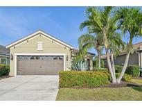 Charming single-story home with a two-car garage, well-maintained lawn, and mature tropical landscaping at 4016 Azurite Way, Bradenton, FL 34211
