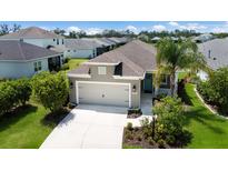 Charming single-Gathering home with a lush green lawn and a well-maintained two-car garage with great curb appeal at 4815 Deep Creek Ter, Parrish, FL 34219