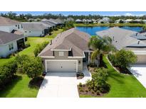Charming single-Gathering home features a two-car garage, manicured landscaping, and a serene lake view in a friendly neighborhood at 4815 Deep Creek Ter, Parrish, FL 34219