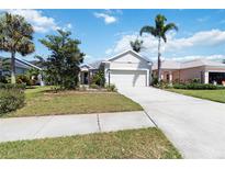 Charming single-story home featuring a well-manicured lawn and a spacious two-car garage at 5227 Aqua Breeze Dr, Bradenton, FL 34208