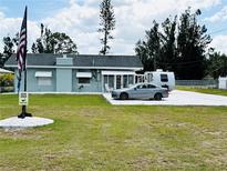 Charming single-story home with a well-maintained lawn, white gravel driveway, and the US flag waving proudly at 612 Shore Rd, Nokomis, FL 34275
