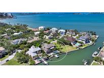 Stunning aerial view of waterfront property featuring a pool, boat dock, and lush landscaping at 975 Whitakers Ln, Sarasota, FL 34236