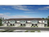 New townhomes with individual garages and manicured lawns under a bright blue sky at 15153 Cuzcorro Ct, Nokomis, FL 34275