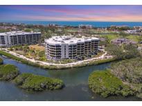 Stunning aerial view of the condo complex, highlighting its waterfront location and lush landscaping at 2120 Harbourside Dr # 621, Longboat Key, FL 34228