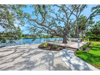 Stunning backyard oasis with deck, mature trees, and water access on the canal at 5377 Palos Verdes Dr, Sarasota, FL 34231