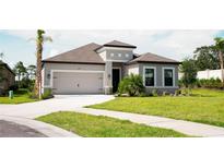 Charming single-story home with a well-maintained lawn and attached two-car garage at 5684 Blue Reef Place, Nokomis, FL 34275