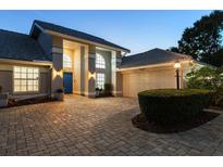 Charming single-story home with mature landscaping, paver driveway, and a welcoming blue front door at 6702 Drewrys Blf, Bradenton, FL 34203