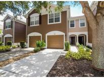 Charming townhome featuring a well-manicured lawn, attached garage, and inviting front entrance at 7192 83Rd E Dr, Bradenton, FL 34201