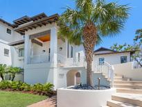 Stunning front exterior featuring a lush palm tree, elegant staircase, and modern architectural design at 7333 Point Of Rocks Rd, Sarasota, FL 34242