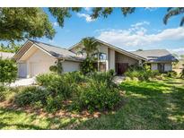 Charming home with a modern design, mature landscaping, and double door entry at 8142 Misty Oaks Blvd, Sarasota, FL 34243