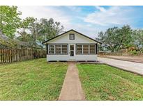 Attractive home showcasing lush lawn, gravel drive, walkway, and classic black and white color scheme, presenting curb appeal at 1016 38Th W St, Bradenton, FL 34205