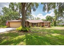 Charming single-story home with a well-manicured lawn and mature trees offering ample shade at 1143 131St E St, Bradenton, FL 34212